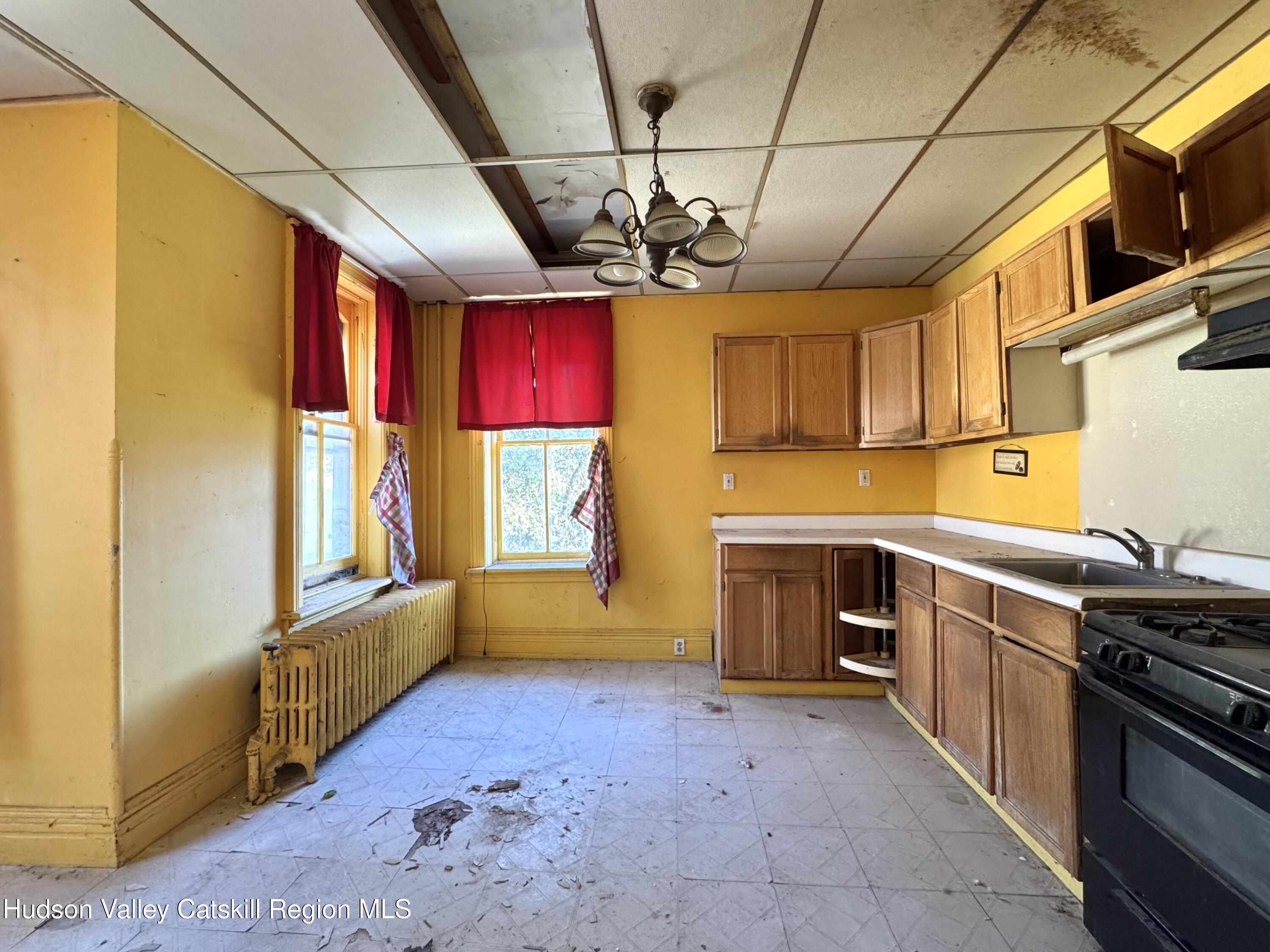 8 Howell Street Catskill, NY 12414 - Photo 4 of 14 a kitchen with stainless steel appliances granite countertop a stove a sink dishwasher and a refrigerator