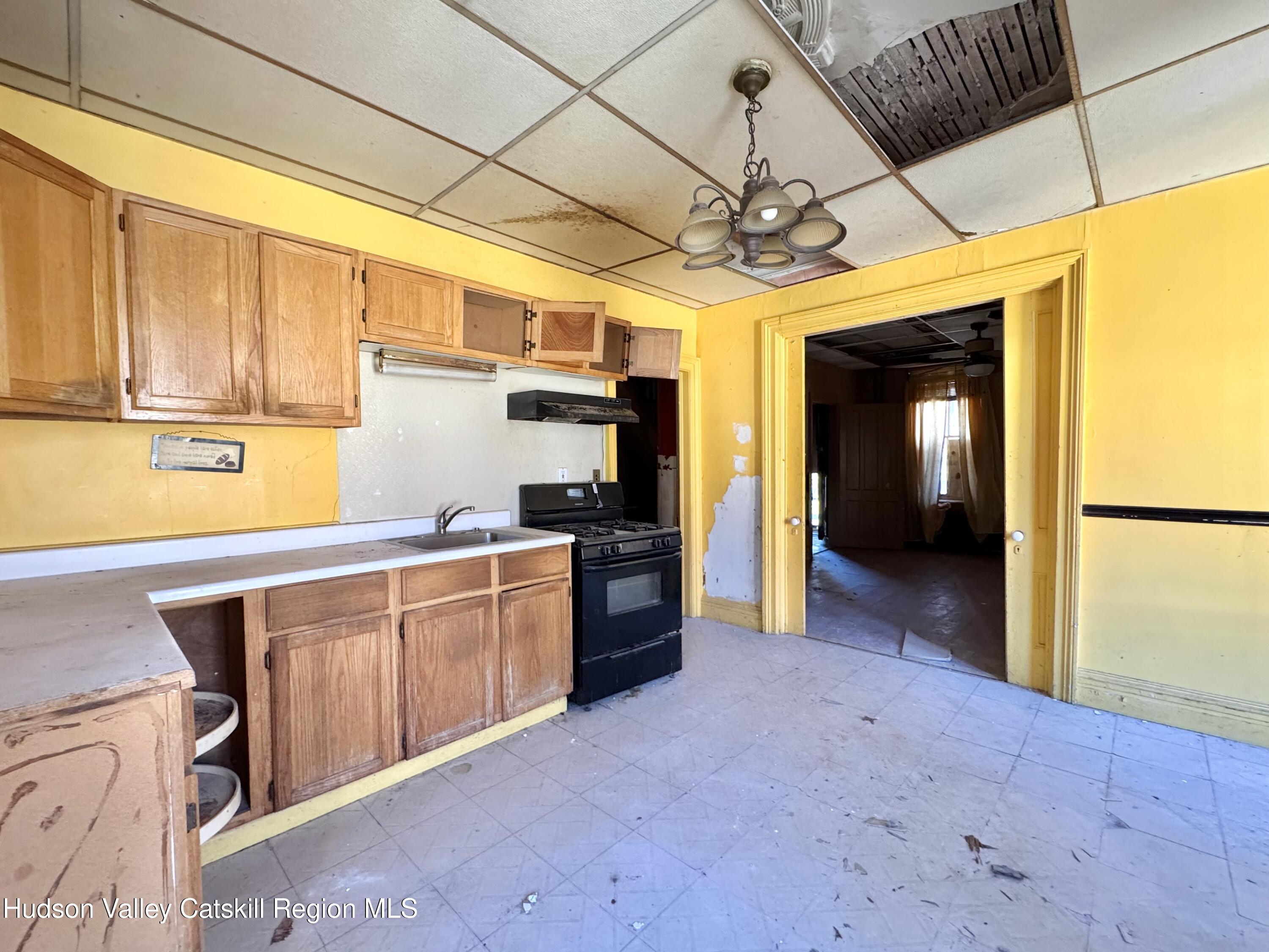 8 Howell Street Catskill, NY 12414 - Photo 5 of 14 a kitchen with cabinets a sink and appliances