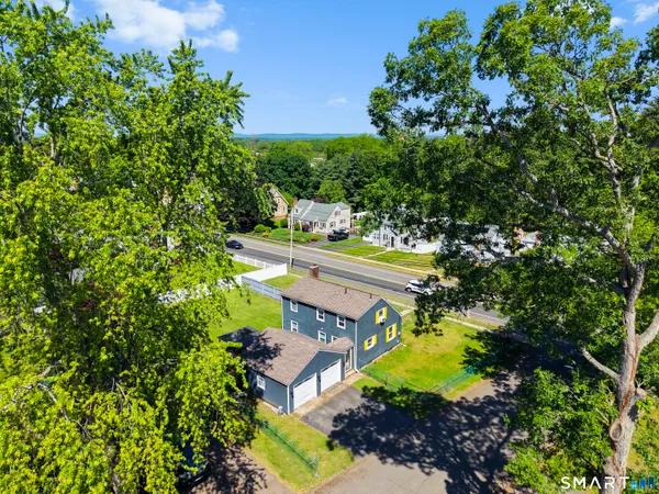an aerial view of a house with a yard swimming pool a patio and yard