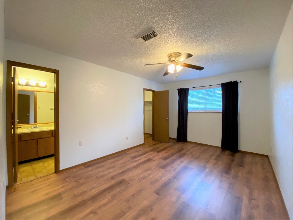 5502 Honey Dew Terrace Austin, TX 78749 - Photo 11 of 18 a view of empty room with wooden floor and fan