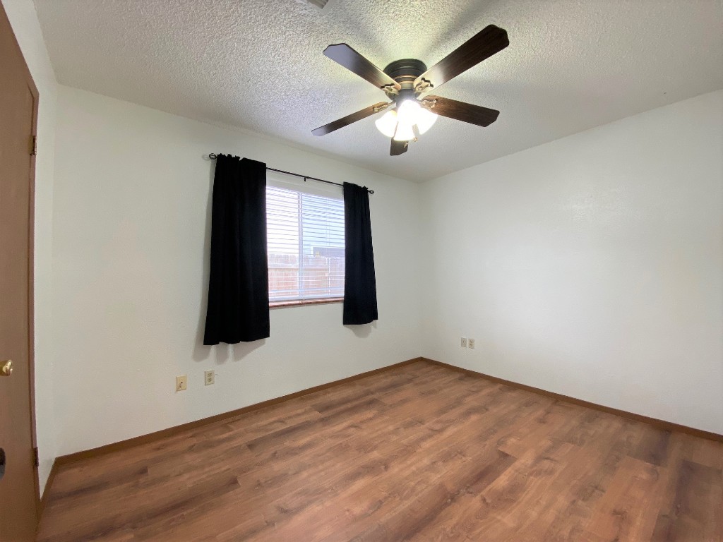 5502 Honey Dew Terrace Austin, TX 78749 - Photo 13 of 18 an empty room with wooden floor and windows