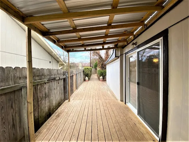 a view of a balcony with wooden floor