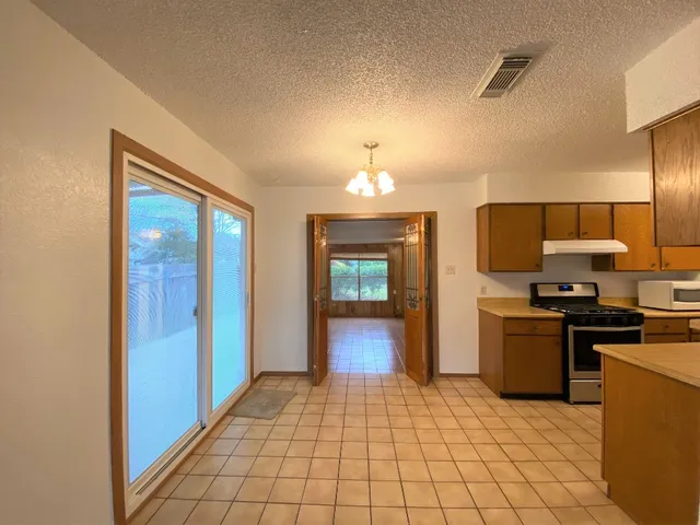 a view of a kitchen with a sink and dishwasher cabinets