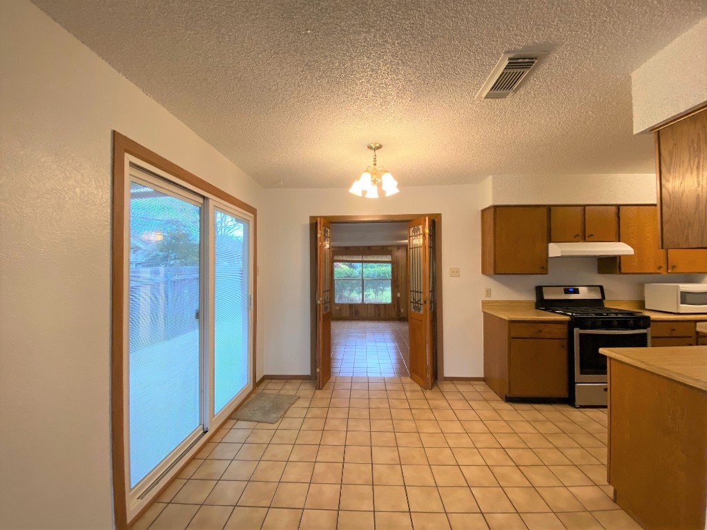 5502 Honey Dew Terrace Austin, TX 78749 - Photo 9 of 18 a view of a kitchen with a sink and dishwasher cabinets