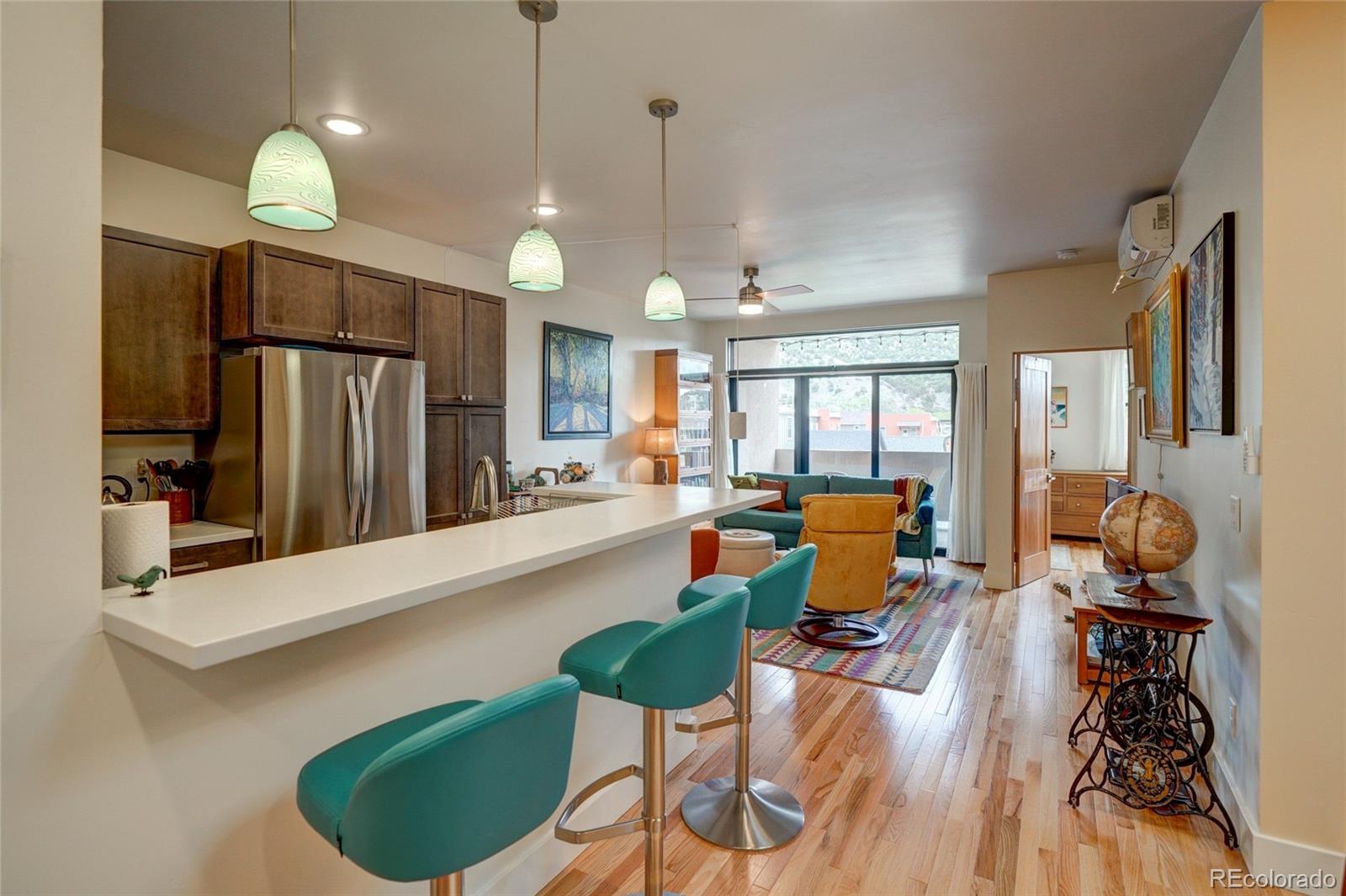 108 Old Stage Road, Unit C Salida, CO 81201 - Photo 11 of 30 a large kitchen with a table chairs refrigerator and microwave