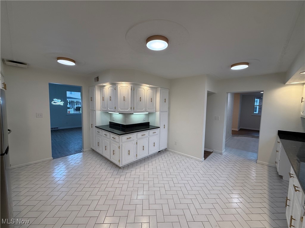 522 North 3rd Street Toronto, OH 43964 - Photo 11 of 47 Kitchen featuring white cabinets, freestanding refrigerator, and dark stone countertops