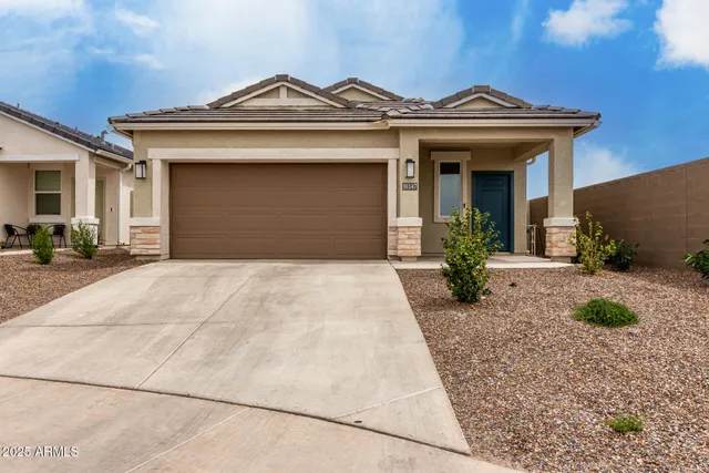 a view of a house with a small yard and plants