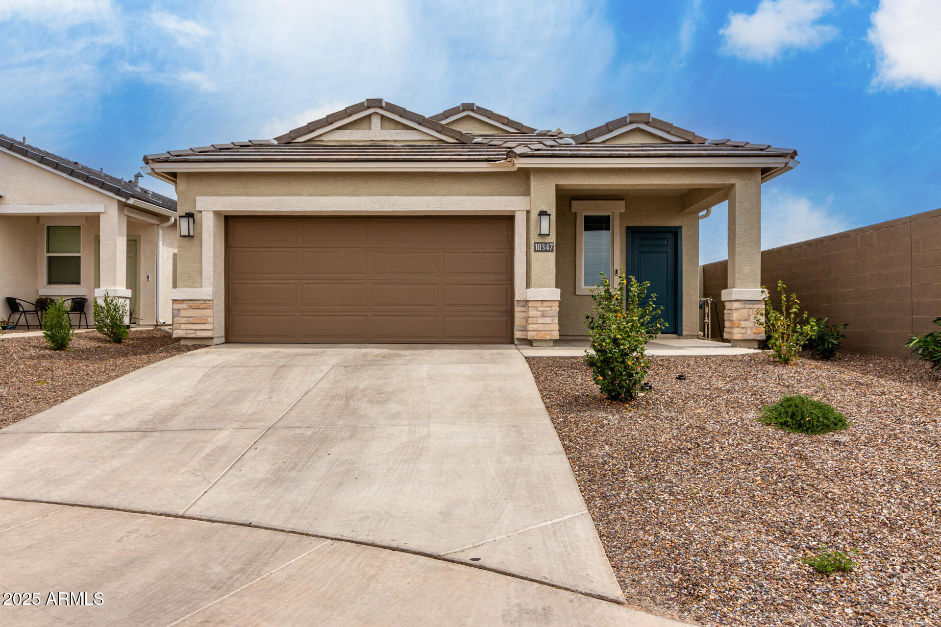 a view of a house with a small yard and plants