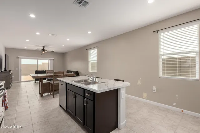 a kitchen with a counter top space a sink stainless steel appliances and cabinets