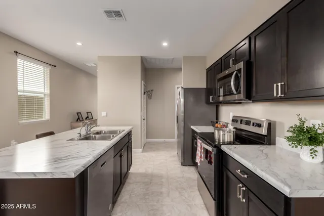 a kitchen with a stove sink and microwave