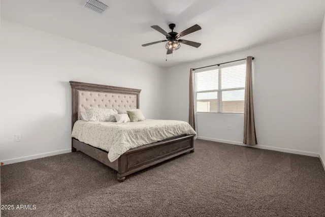 a bed sitting in a bedroom next to a window