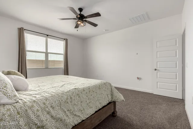 a bedroom with a large bed and a window