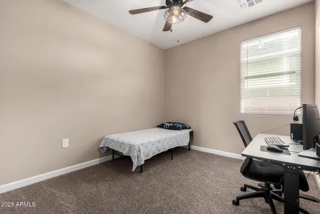 a bedroom with a bed and a flat tv screen