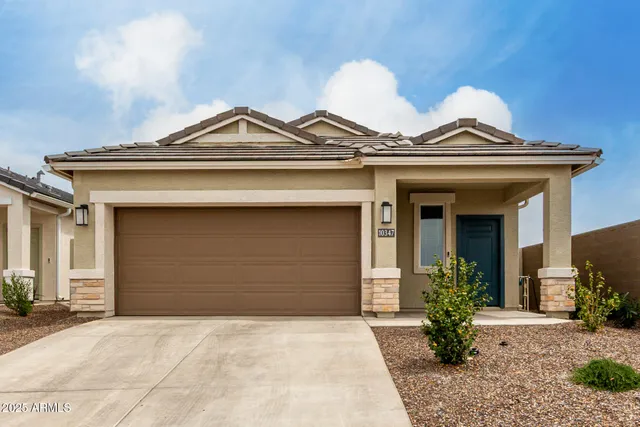a view of a house with a small yard and plants