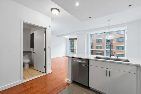 a view of a kitchen cabinets a sink and wooden floor