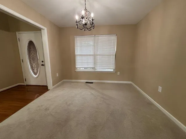 a bathroom with a granite countertop sink and a large mirror