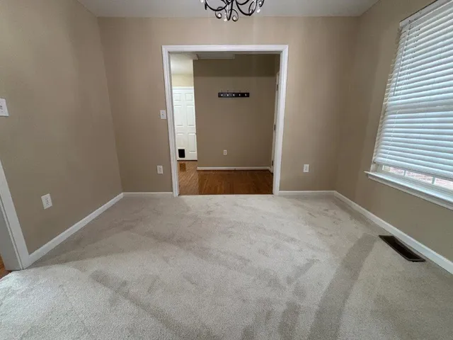 a spacious bathroom with a double vanity sink a large mirror and a bathtub