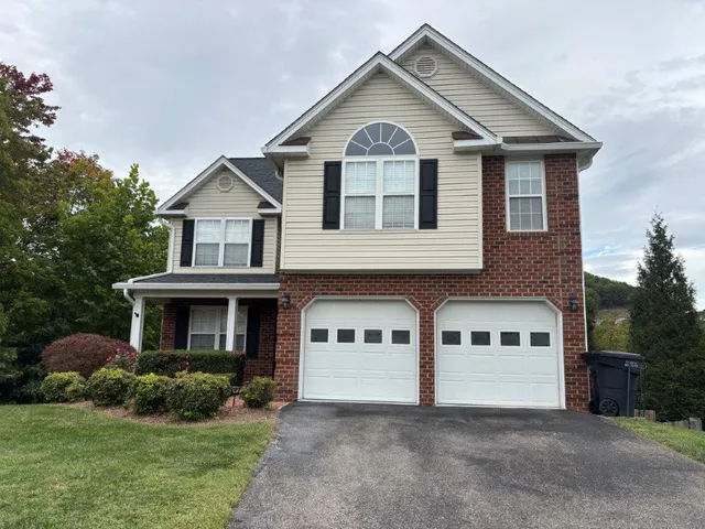 a front view of a house with yard and garage