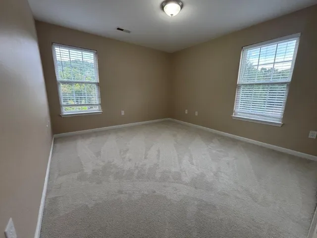 a view of a house with a yard and a large window