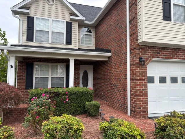a view of an empty room with a fireplace and a window