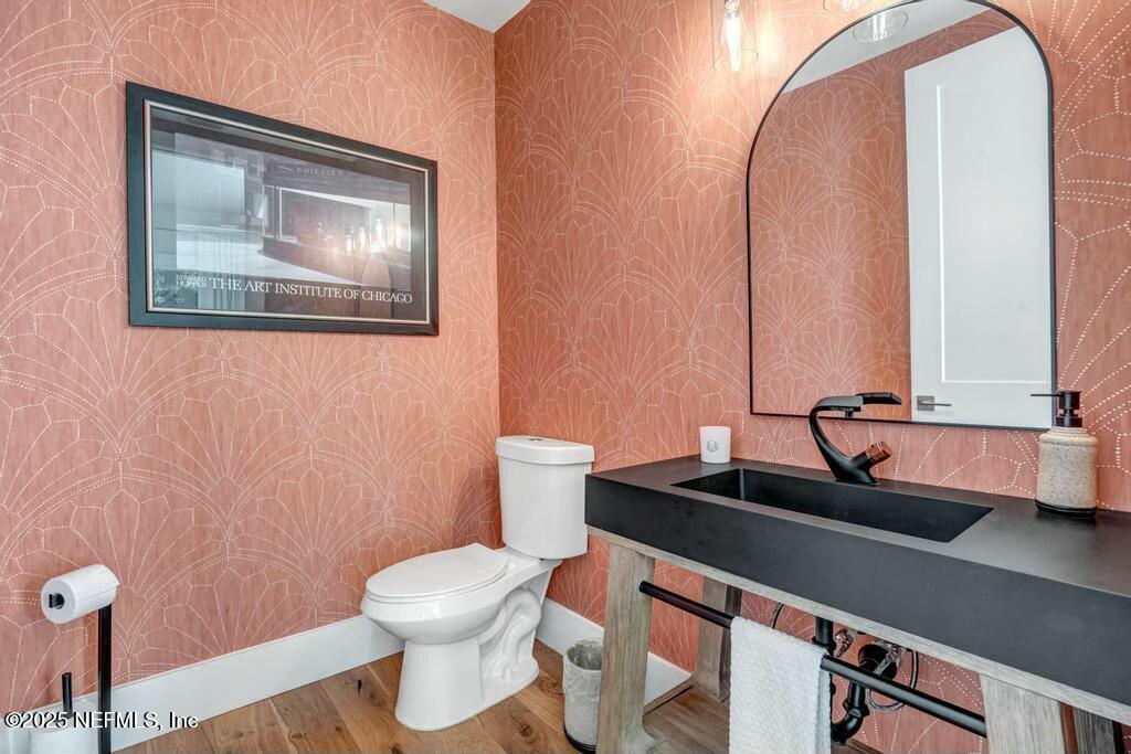 564 A1A North Ponte Vedra Beach, FL 32082 - Photo 17 of 34 a bathroom with a toilet sink and mirror