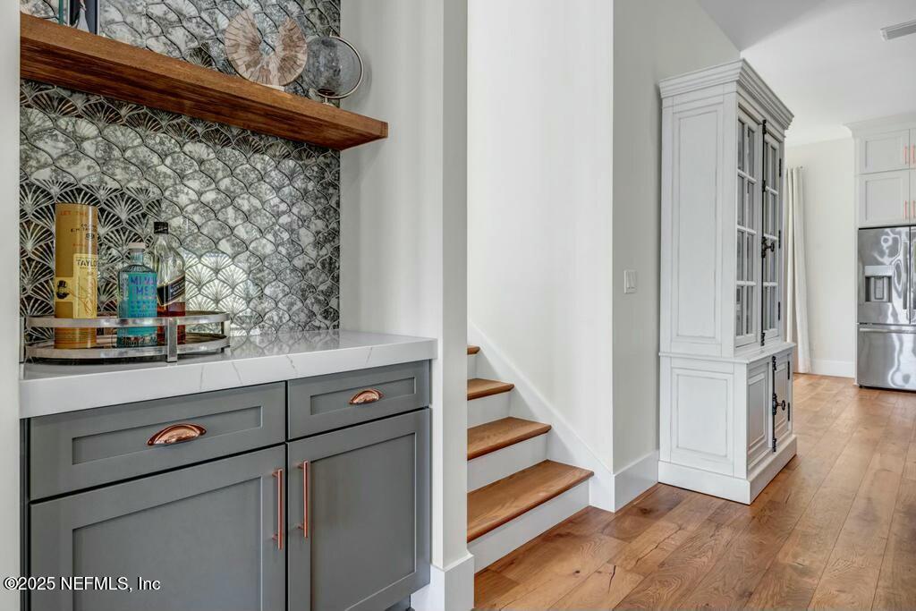 564 A1A North Ponte Vedra Beach, FL 32082 - Photo 20 of 34 a view of a hallway with wooden floor and staircase