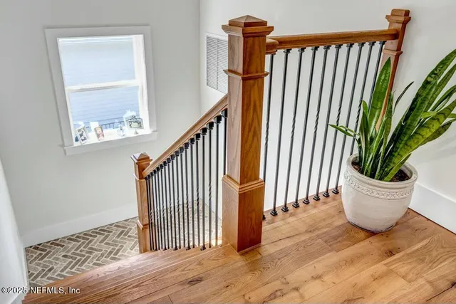 a view of a room with wooden floor and stairs