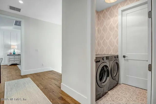 a view of a bedroom with washer and dryer