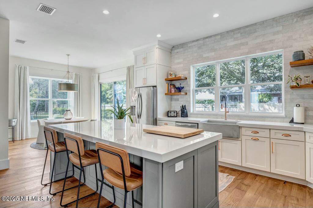 564 A1A North Ponte Vedra Beach, FL 32082 - Photo 5 of 34 a kitchen with stainless steel appliances granite countertop a table chairs sink and cabinets