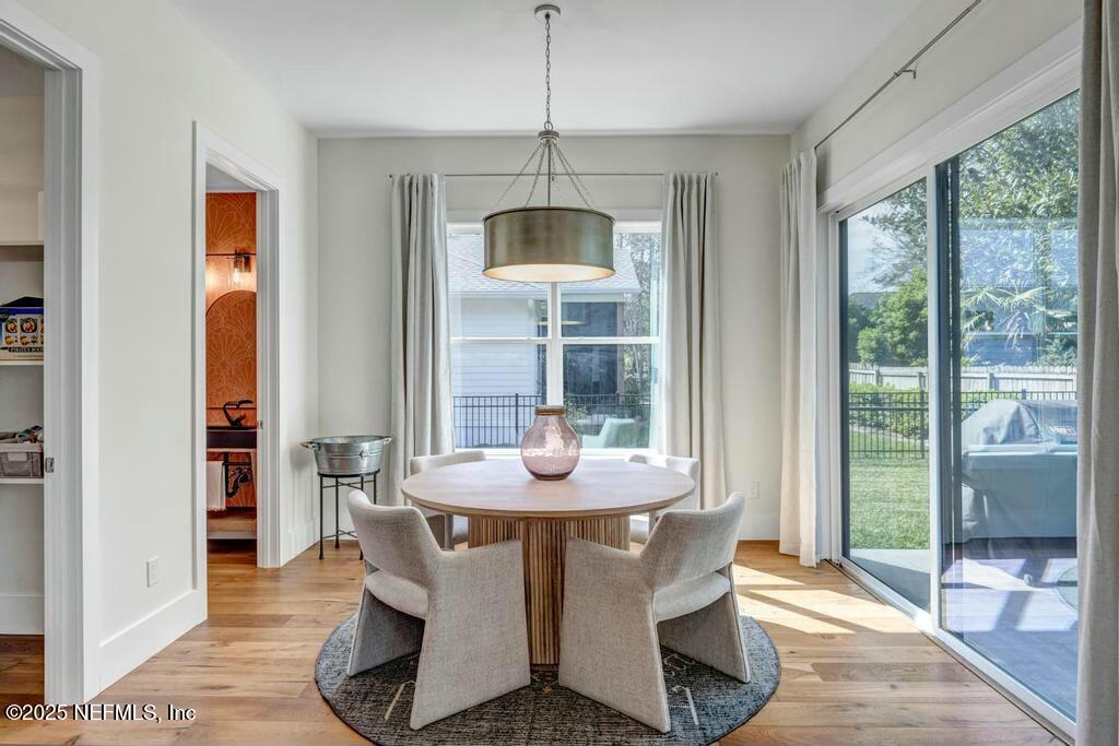 564 A1A North Ponte Vedra Beach, FL 32082 - Photo 6 of 34 a dining room with furniture wooden floor and a chandelier
