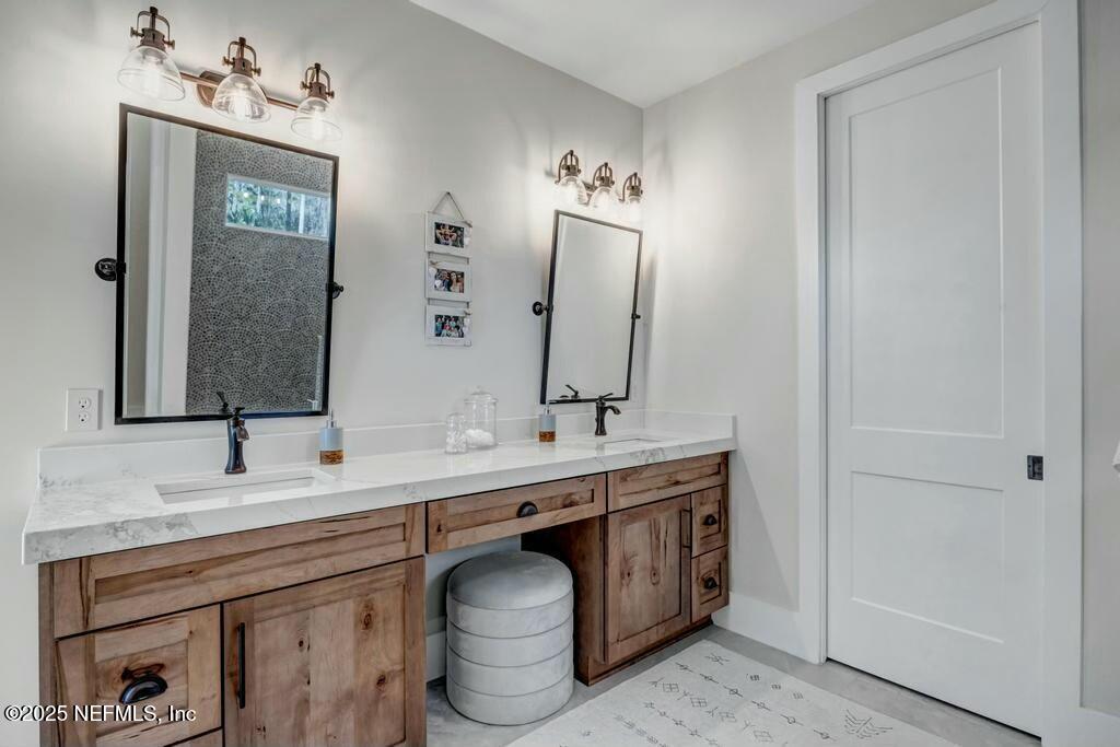 564 A1A North Ponte Vedra Beach, FL 32082 - Photo 8 of 34 a bathroom with a toilet sink and mirror