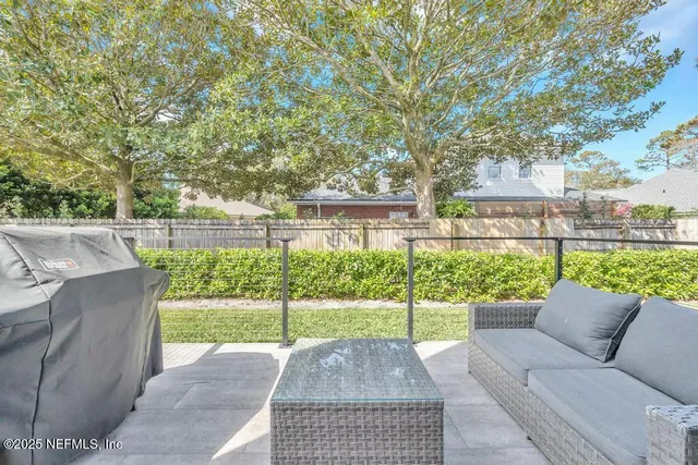 a view of a patio with couches and city view
