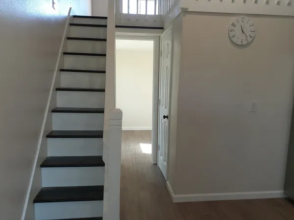 a view of entryway with stairs and windows