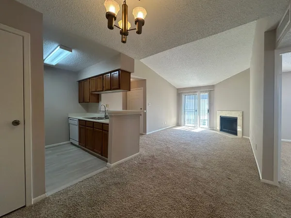 a view of an empty room with a chandelier