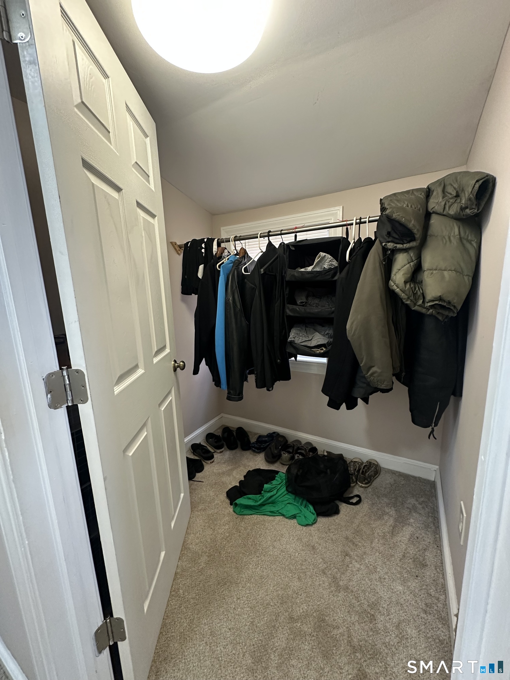 1031 Meriden Road Waterbury, CT 06705 - Photo 17 of 30 a view of walk in closet with clothes and shoes