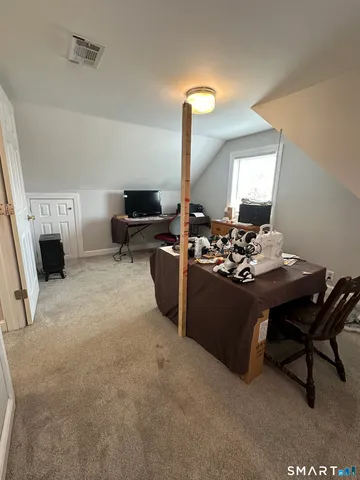 a living room with furniture and a mirror