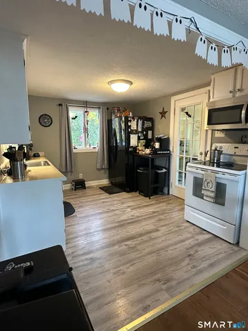 a kitchen with stainless steel appliances kitchen island granite countertop a refrigerator stove and sink