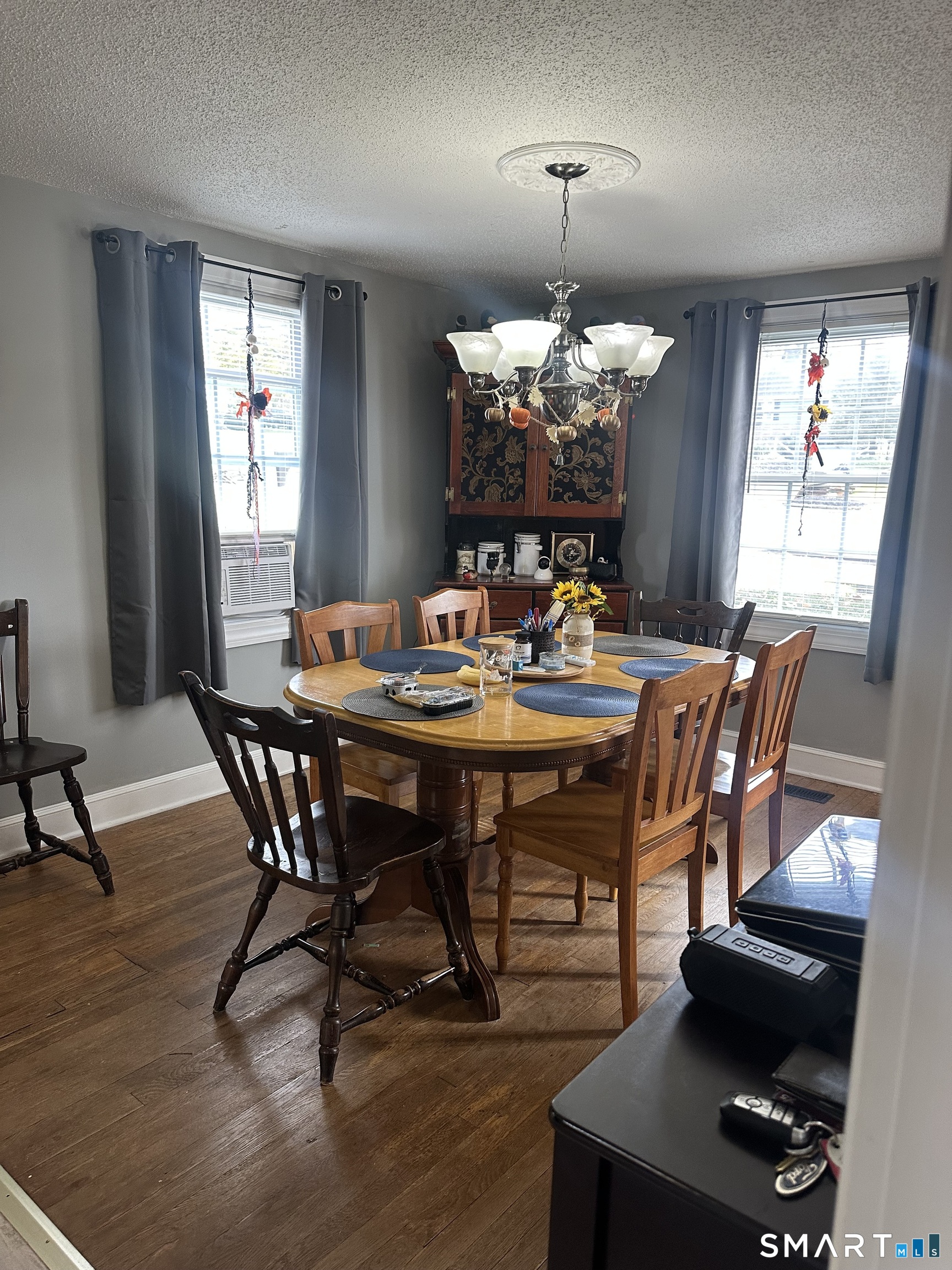 1031 Meriden Road Waterbury, CT 06705 - Photo 5 of 30 a dining room with furniture a chandelier and wooden floor