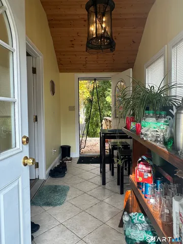 a dining room with furniture and a floor to ceiling window