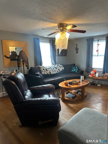 a living room with furniture and a chandelier