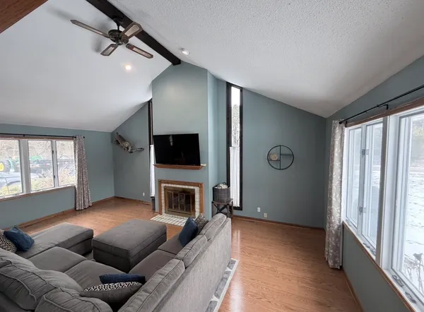 a living room with furniture flat screen tv and a fireplace