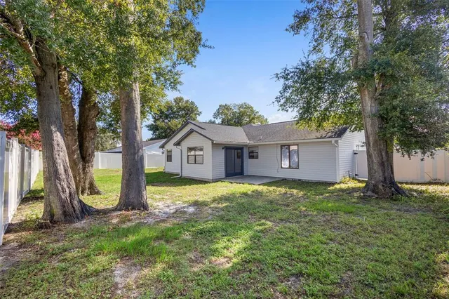 a view of a backyard with a garden and trees