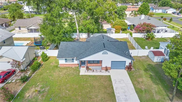 an aerial view of a house with a yard
