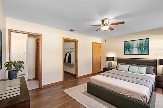 a bedroom with a bed and a potted plant