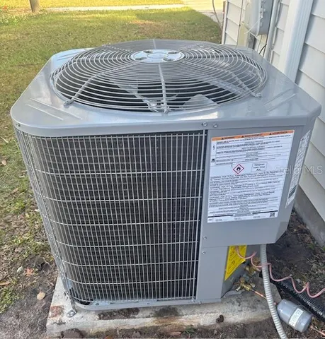 a view of a house with a yard and potted plants