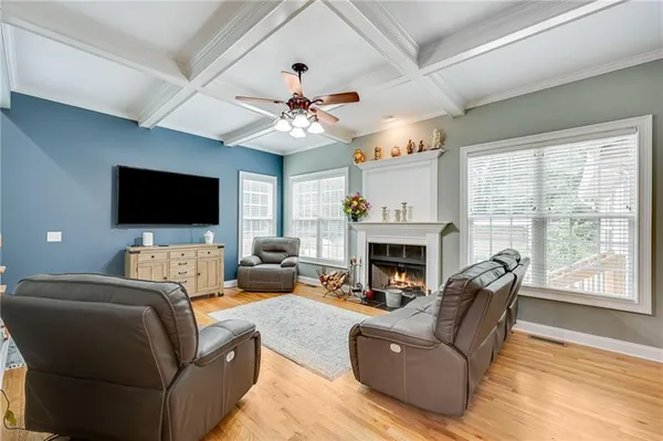 a living room with furniture a fireplace and a flat screen tv