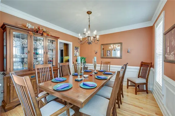a view of a dining room with furniture wooden floor and chandelier