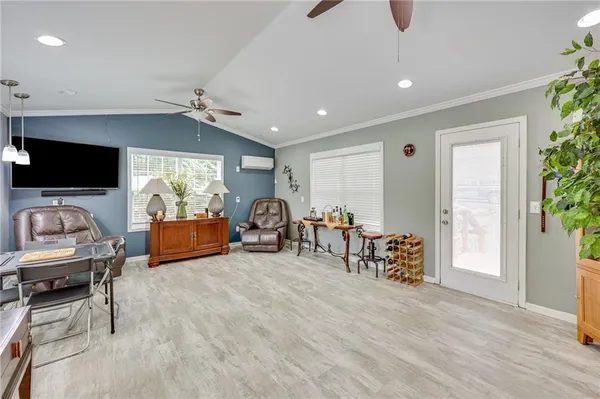 a view of a livingroom with furniture and a flat screen tv