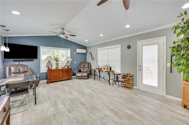 a view of a livingroom with furniture and a flat screen tv