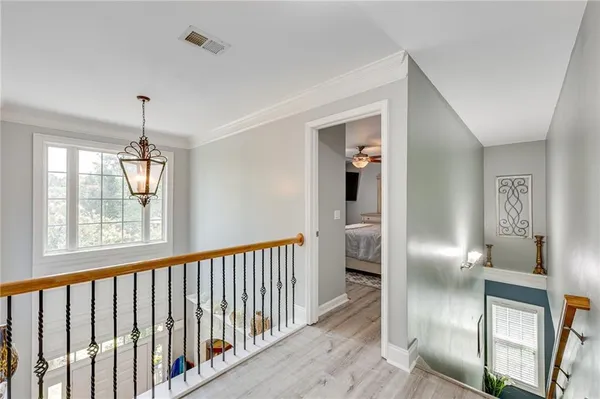 a view of a hallway with wooden floor and entryway